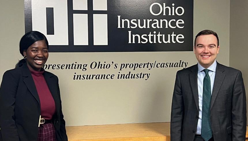 A student stands with a staff member from the Ohio Insurance Institute.