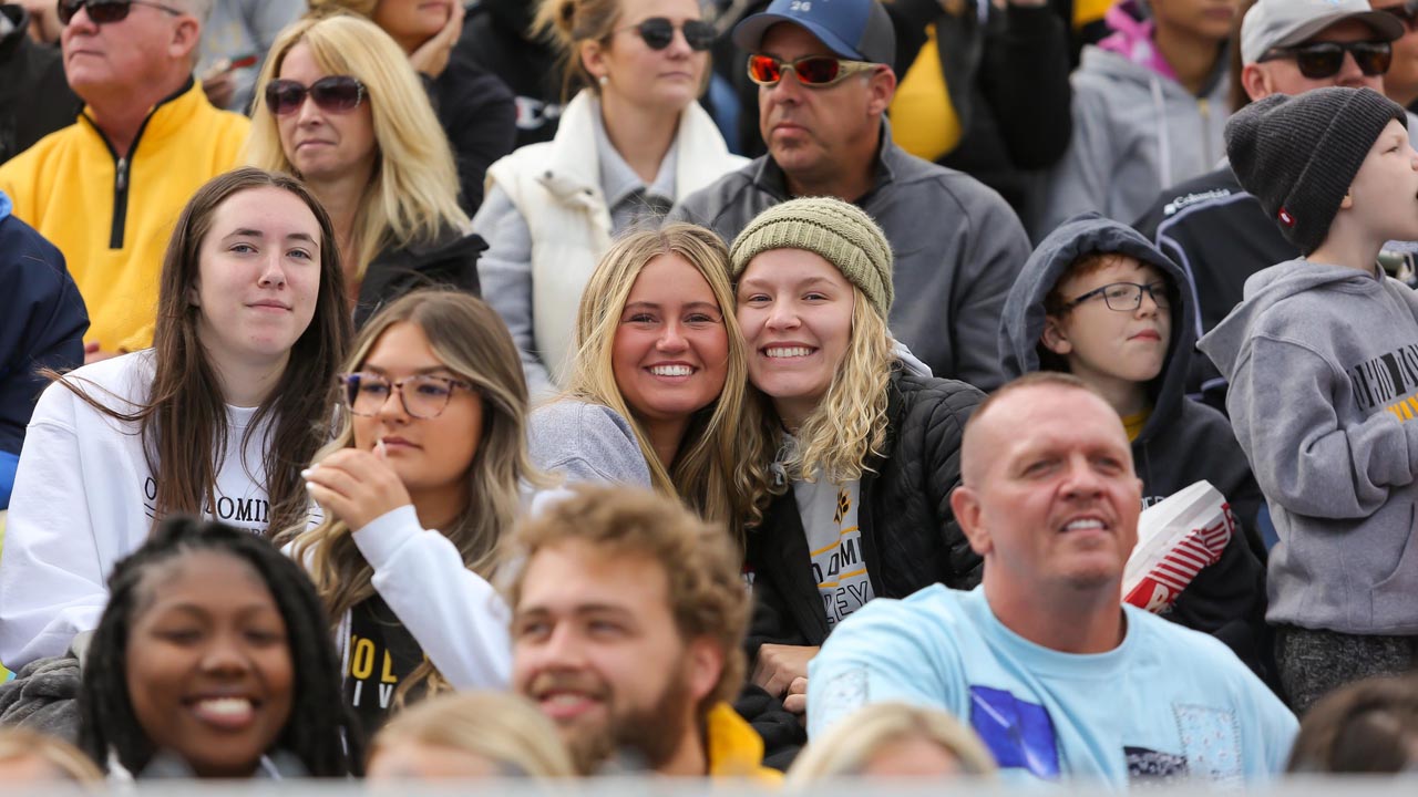 ODU fans in the stands smile for the camera during the game.