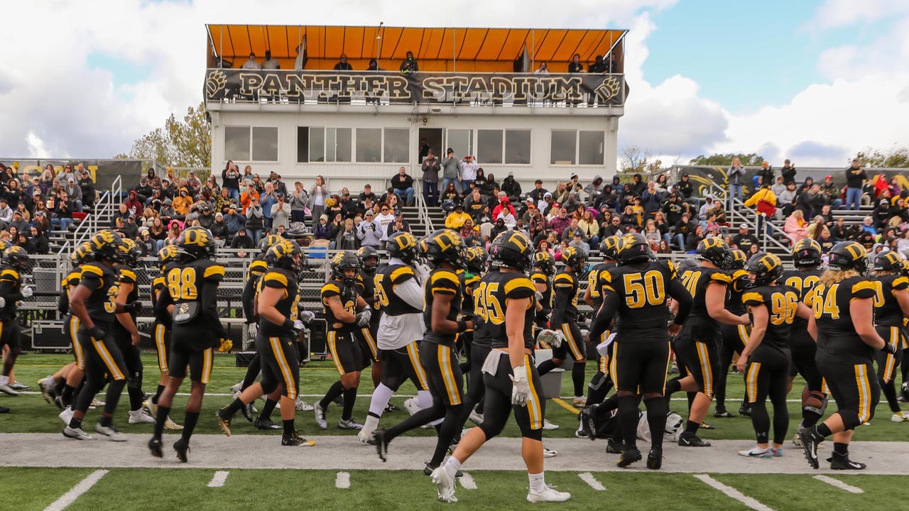 The Panthers take the field as the stadium full of fans cheer them on.