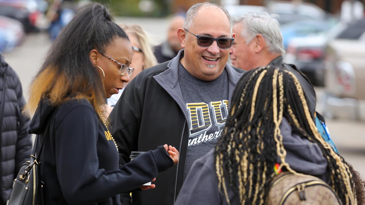 Panther fans and alumni chatting outside Panther stadium.