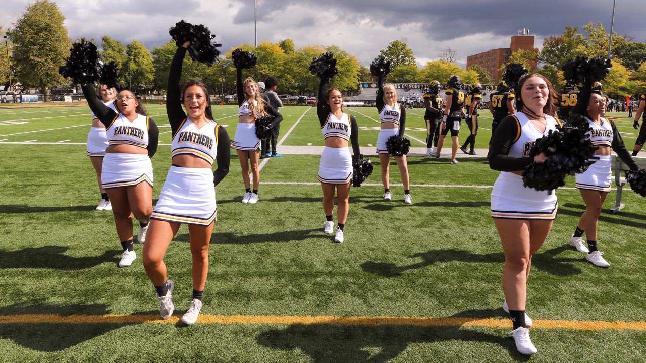 ODU cheerleaders cheer on the Panthers on the field.