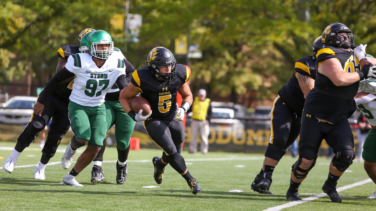 The ODU football team runs the ball. 