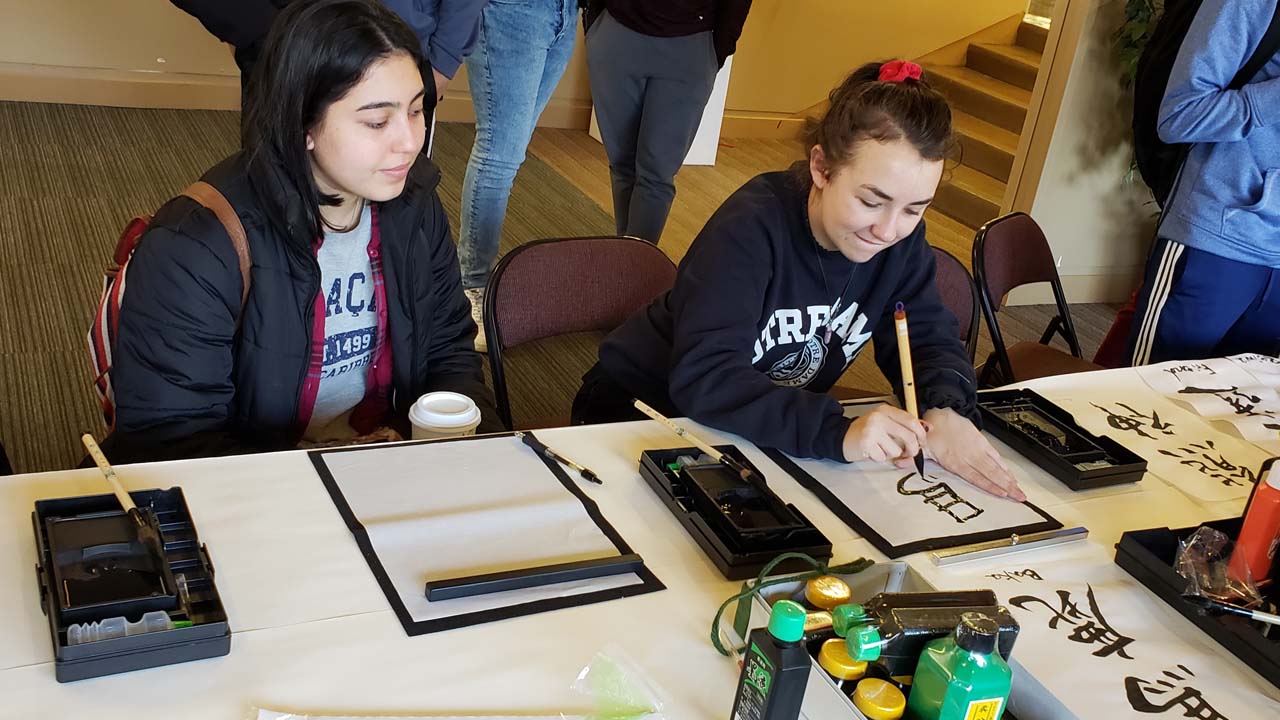 Students take part in a Chinese/Japanese calligraphy workshop.