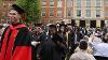 Faculty and graduates exit the Erskine Oval during the Recessional following the ceremony.