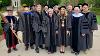 Members of the Commencement stage party gather before Commencement for a photo in front of Wehrle Hall.